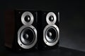 Modern powerful audio speakers on black table Royalty Free Stock Photo