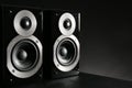 Modern powerful audio speakers on black table. Space for text Royalty Free Stock Photo