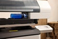 Modern printer and empty bottle indoors, closeup Royalty Free Stock Photo