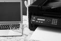 Modern printer, laptop and glasses on white marble table Royalty Free Stock Photo