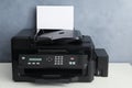 Modern printer with paper on white table Royalty Free Stock Photo