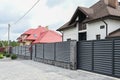 Modern private house with horizontal bars grey steel fence. Neighbours concept Royalty Free Stock Photo