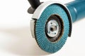 Modern professional angle grinder with a flap wheel on a white background. Power tool for work. Sanding wood and metal