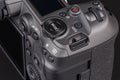 modern professional black digital photo camera controls - buttons, wheels, screens and joystick - close-up macro view