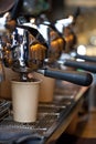 Modern professional espresso machine with coffee pouring into take away paper cup Royalty Free Stock Photo