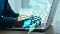Modern Programmer Working on Laptop with Coding Text and Programming Languages Displayed on Screen in a Bright Office Royalty Free Stock Photo