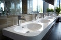 Modern public bathroom with white ceramic wash sink basins and mirror