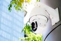 Modern public CCTV camera on a electric pole with blurred building and natural background. Recording camera for monitoring all