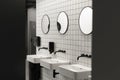 Modern public restroom minimal interior with metro style white tiles, round mirrors, black ceiling and half opened door