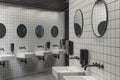 Modern public restroom minimal interior with metro style white tiles, round mirrors, black ceiling.