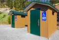 Modern public toilet exterior outdoor. Modern Toilet building, outdoor, summer time in a park. Front view of restroom Royalty Free Stock Photo