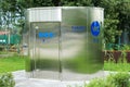 Modern public toilet exterior outdoor. Modern Toilet metal building, outdoor, day time. Front view of modern restroom. Facade of Royalty Free Stock Photo