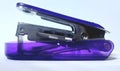 Modern Purple Glass Stapler for an Efficient Office with on paper white background Royalty Free Stock Photo