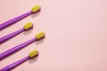 Modern purple kids toothbrushes on a pink background. Copy space for your text