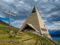 Modern pyramid shaped church and alpine lake in France