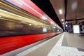 Modern railway station with high speed passenger train on railroad track in motion at night Royalty Free Stock Photo