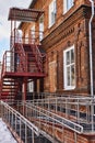 Modern ramp for the disabled and fire escape attached to the old building