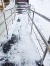 Modern ramp with metal railings for accessible movement of people with disabilities, ramp covered with snow, top view