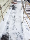 Modern ramp with metal railings for accessible movement of people with disabilities, ramp covered with snow, vertical Royalty Free Stock Photo