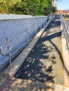 Modern ramp with shiny metal railings outdoors, wheelchair accessible, close-up, vertical Royalty Free Stock Photo