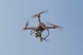 Modern RC Drone / Quadcopter with camera flying in a bright and clear blue sky. New technology in the aero photo shooting Royalty Free Stock Photo