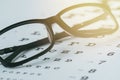 Glasses on the eye sight test chart Royalty Free Stock Photo