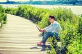 Young man sitting outdoors, reading red book  in New York City Royalty Free Stock Photo