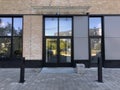 Modern real estate, residential apartment building, entrance with glass canopy door