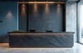 Modern reception desk with black stone texture and built in lighting. Office interior features blue and grey wall panels, marble Royalty Free Stock Photo