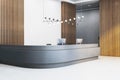 Modern reception desk in a business office lobby with wooden accents, minimalist design, and elegant lighting. Royalty Free Stock Photo