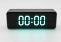 Modern rectangular digital clock displaying zero time with bright neon green numerals Royalty Free Stock Photo