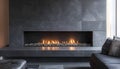 Modern rectangular gas fireplace. Features a dark gray stone surround and a clear view of the burning flames within a Royalty Free Stock Photo