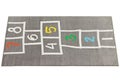 Modern rectangular gray rug with a hopscotch pattern. 3d render