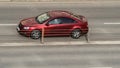 Modern red car moves on city street. Side view of auto on a city road in motion. Car driving fast Royalty Free Stock Photo