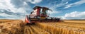 Modern Red Combine Harvester Harvesting Ripe Wheat in Sunny Field Royalty Free Stock Photo