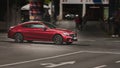 Modern red Mercedes Benz C class coupe (C205) driving on an intersection in Bochum, Germany