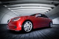 Modern red metallic sedan car in urban setting - tunnel. Generic design, brandless Royalty Free Stock Photo