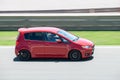 Modern red Mitsubishi Colt sports car in a rally