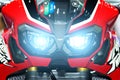 Modern red sport motorcycle headlight with bokeh in night city s
