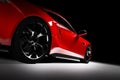 Modern red sports car in a spotlight on a black Royalty Free Stock Photo