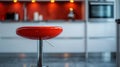 A modern red stool in a contemporary kitchen setting. Royalty Free Stock Photo