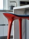Modern red stool in a contemporary kitchen setting. Royalty Free Stock Photo