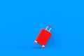 Modern red suitcases bag on blue background. Travel concept. Vacation trip. Copy space. Minimal style.