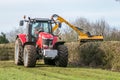 Modern red tractor hedge cutting