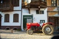 Modern red tractor on the village road