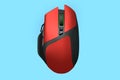 Modern red wireless gaming computer mouse isolated on blue background Royalty Free Stock Photo