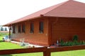 Modern, reddish wooden summer house at the lake's shore in Europ