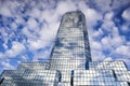 A modern reflective office skyscraper against a blue sky with white clouds. Warsaw, Poland Royalty Free Stock Photo