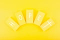 Modern religious minimal concept of hope with christian cross on bright yellow background Royalty Free Stock Photo