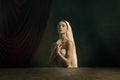 Modern remake of classical artwork. Young medieval woman on dark background Royalty Free Stock Photo